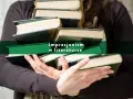 Dłonie trzymają stos starych książek, a na zielonym tle widnieje napis "impresjonizm w literaturze".